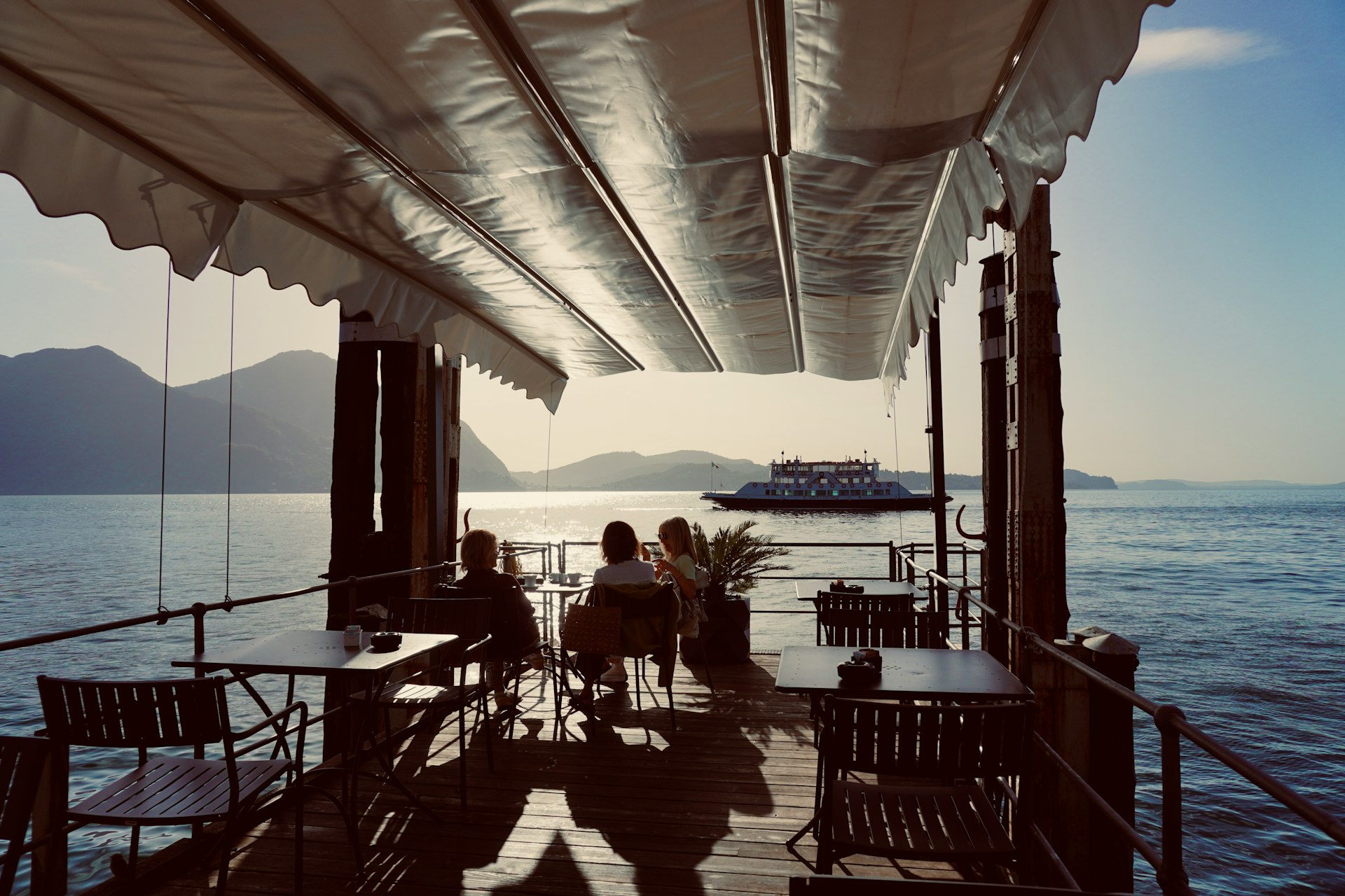 a group of people sitting at a table on a boat